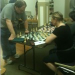 Anthea Carson playing against GM Alex Fishbein in a simul at the Denver Chess Club